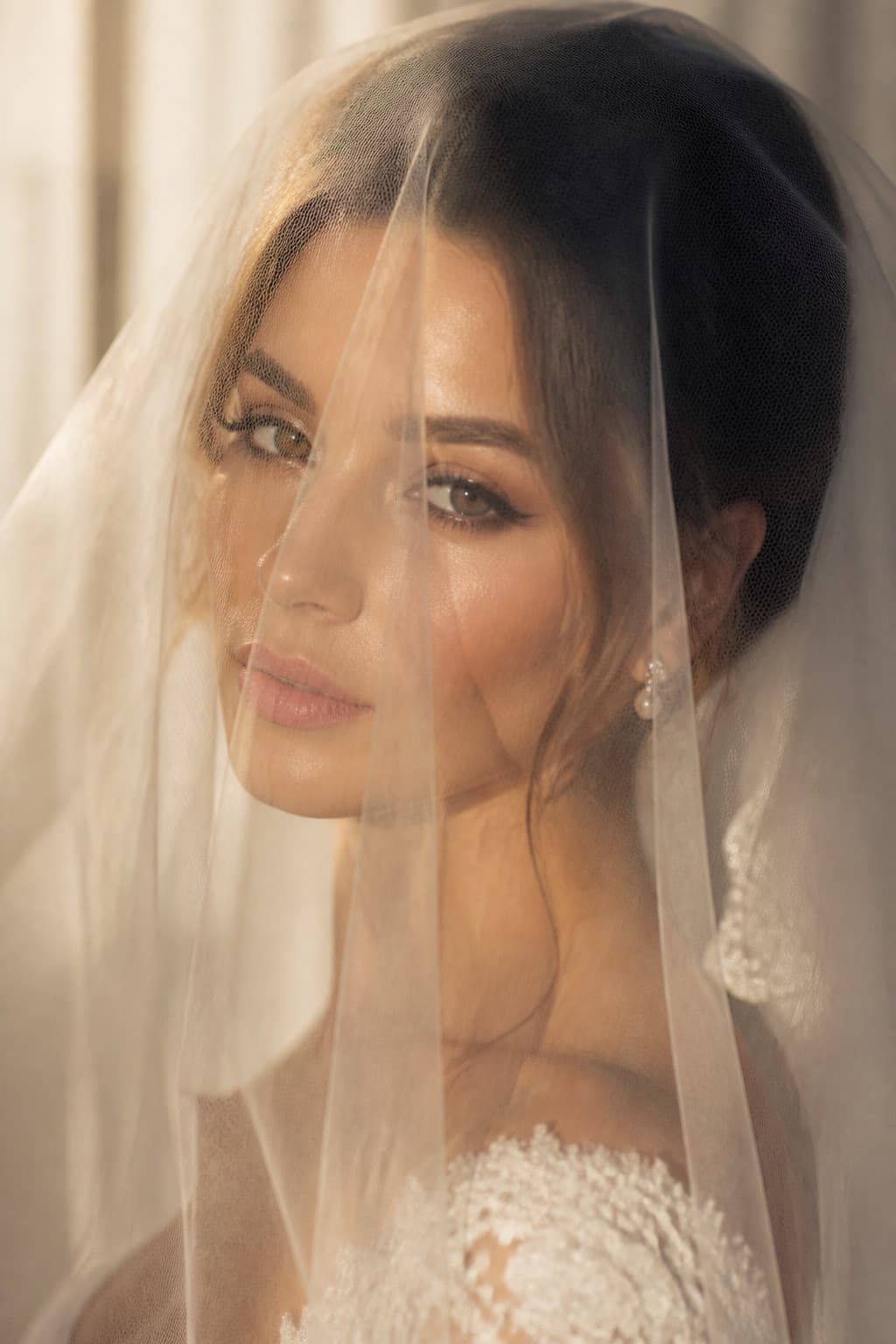 Bride in a sheer cathedral veil with romantic makeup